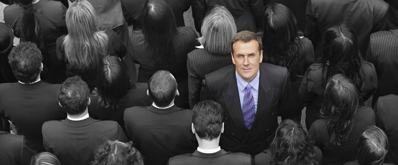 High angle view of a businessman standing amidst businesspeople